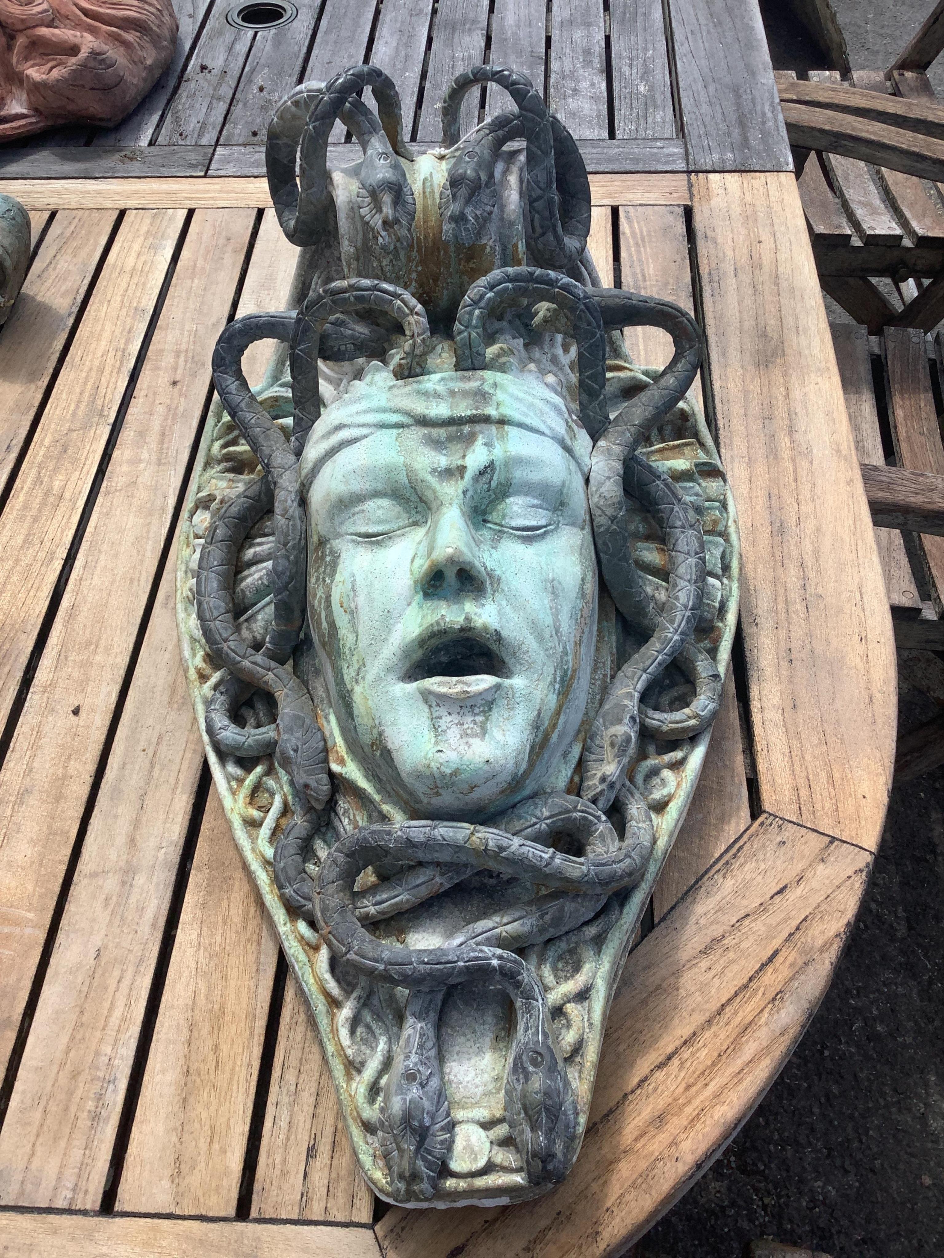 A reconstituted marble and lead Medusa wall fountain head, height 54cm